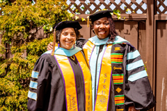 Two graduates posing